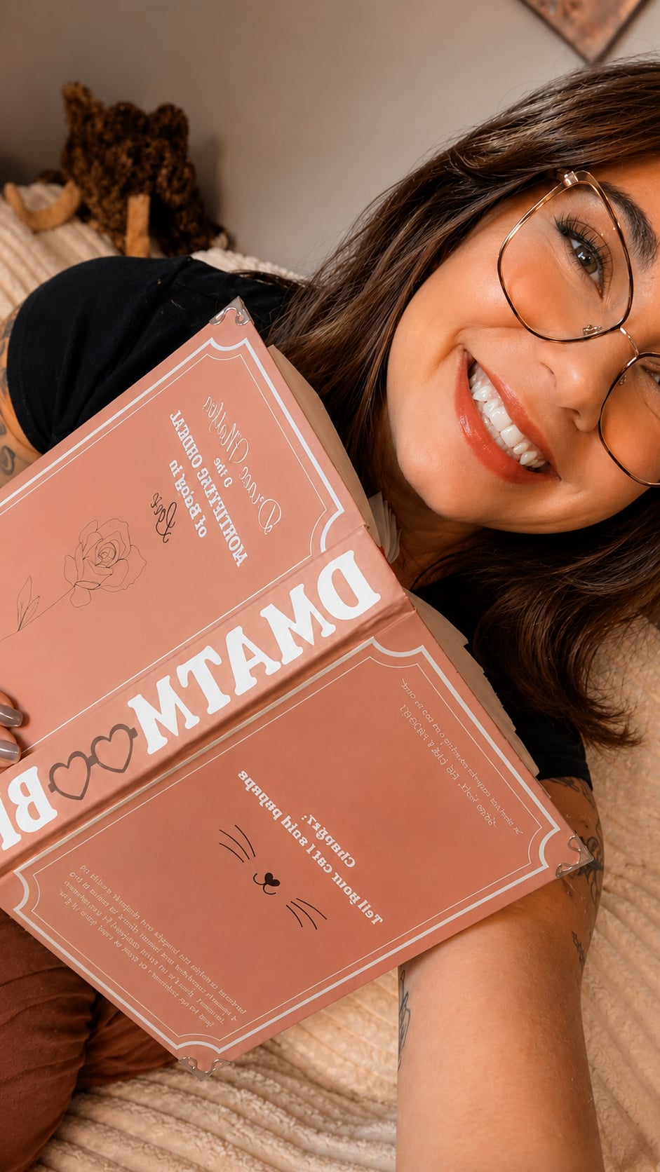 Kaylee, the smiling maker behind Storybound Studios, holding a handmade pink bookish display